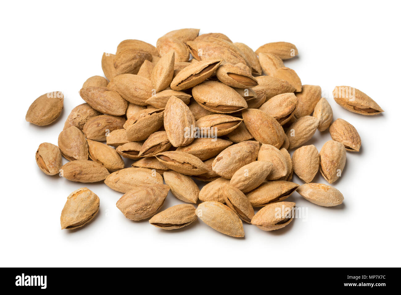 Heap of fresh unpeeled almonds isolated on white background Stock Photo