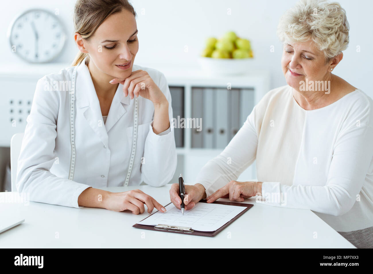 Dietician and diabetic patient with measure tape discussing daily