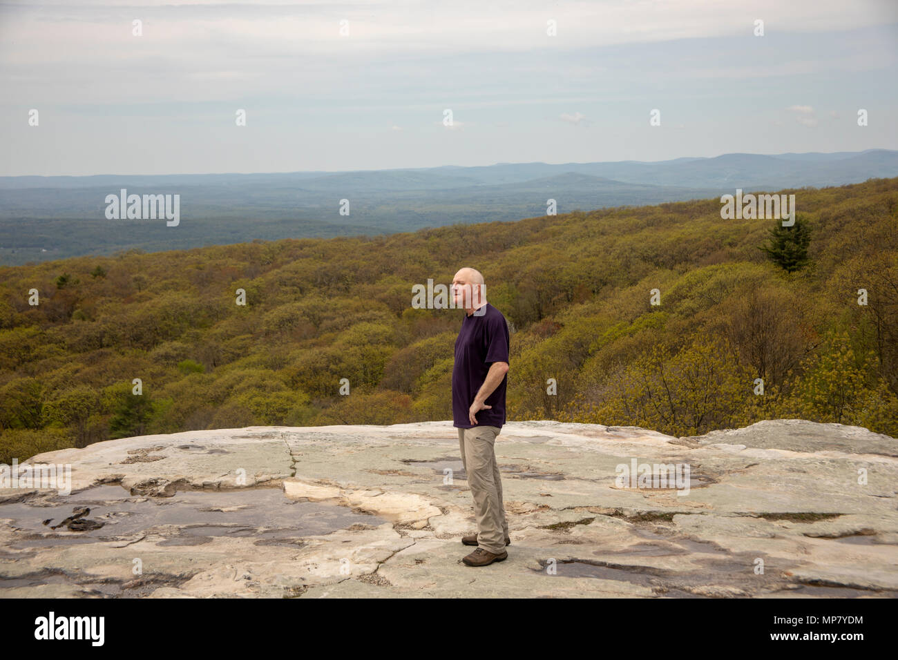 Senior male hiker standing on Sam's Point Overlook, Ulster County, New