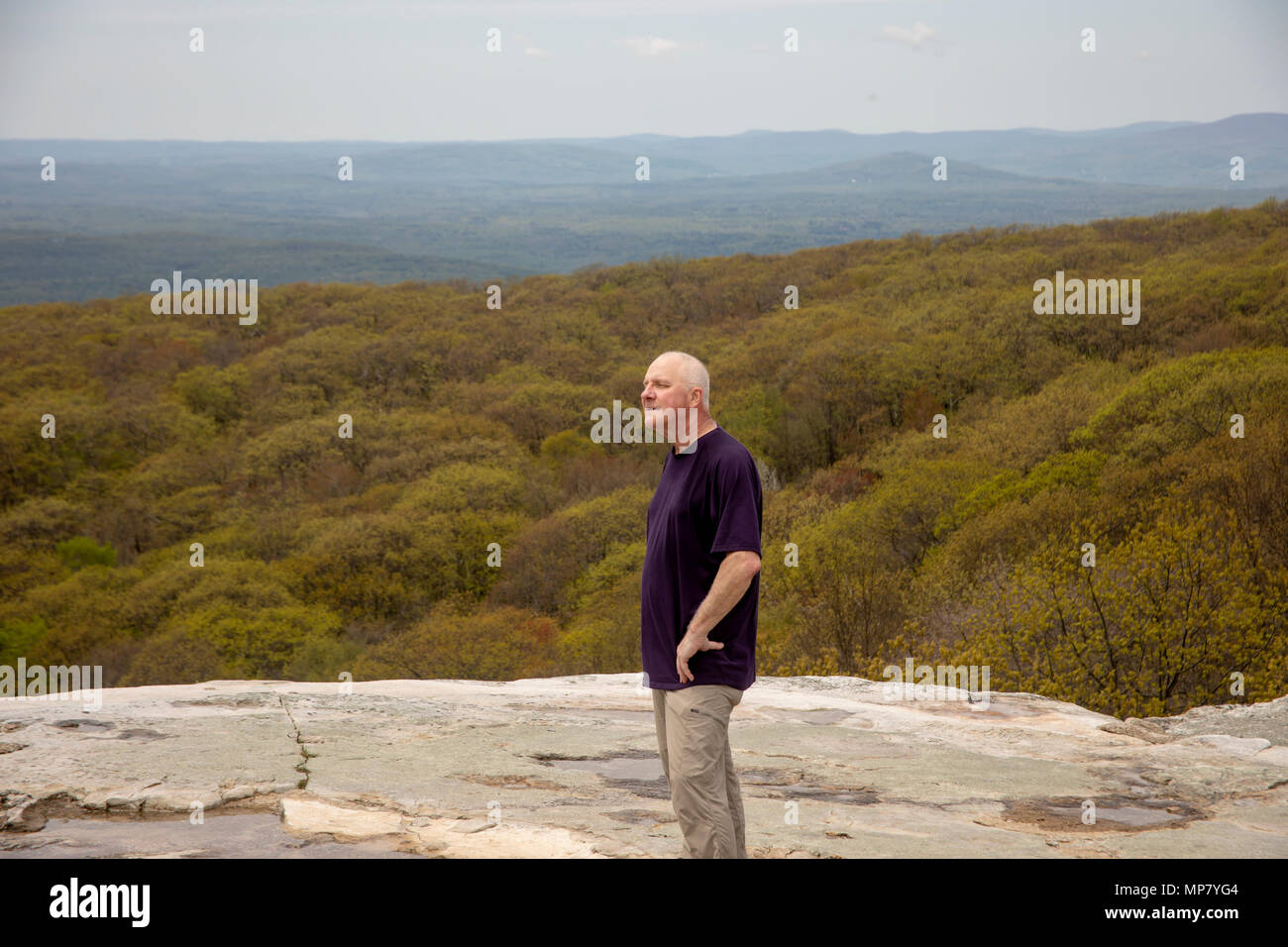 Senior male hiker standing on Sam's Point Overlook, Ulster County, New