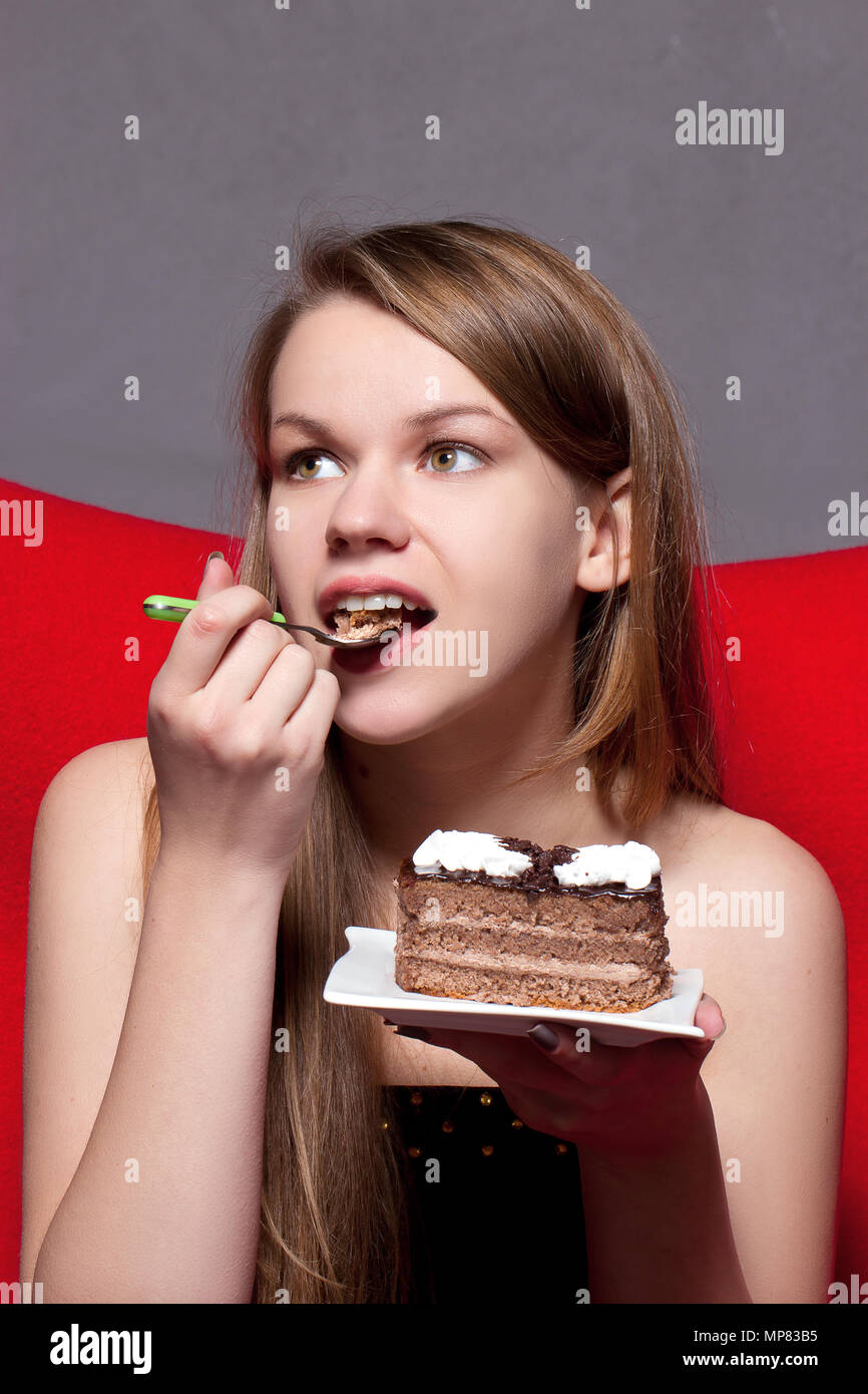 girl with pleasure eats chocolate cake Stock Photo Alamy