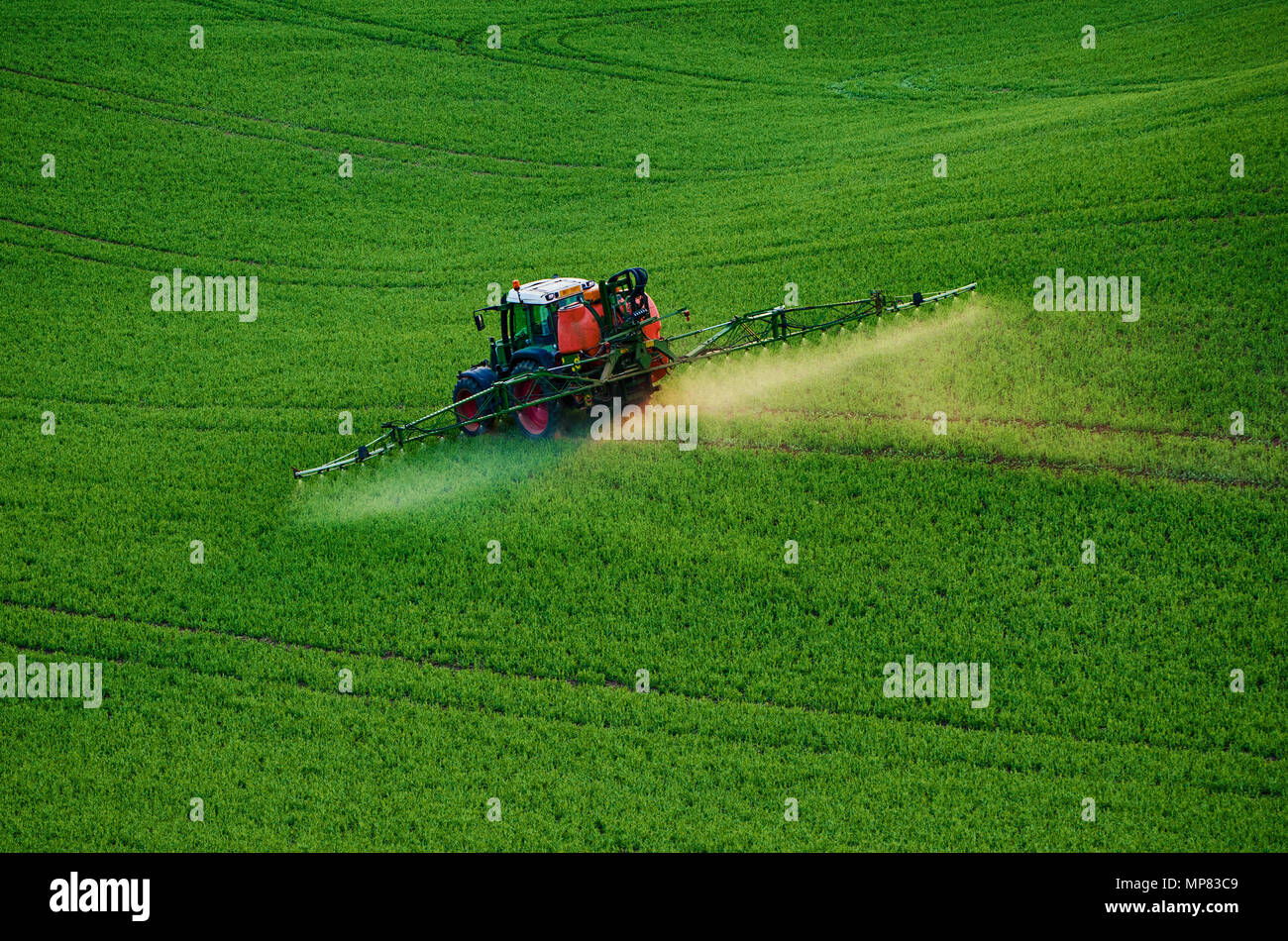 Farm machinery spraying insecticide Stock Photo