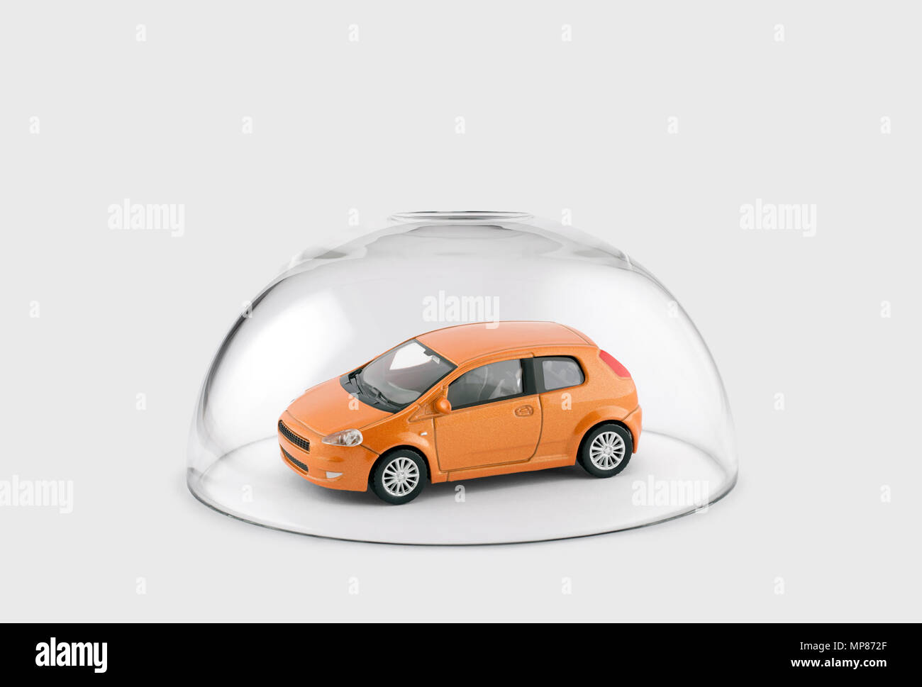 Orange car protected under a glass dome Stock Photo