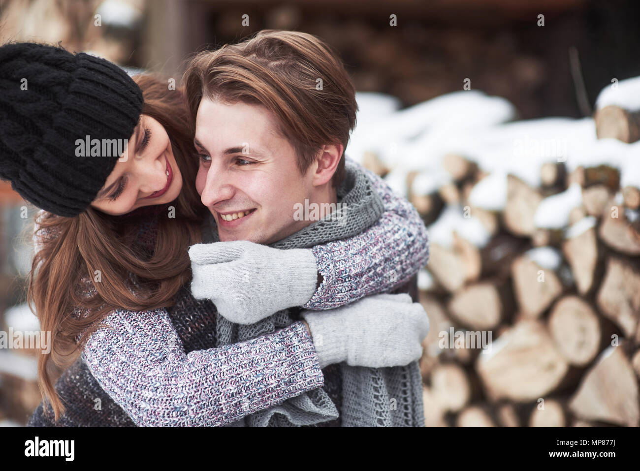 christmas happy couple in love embrace in snowy winter cold forest, copy space, new year party celebration, holiday and vacation, travel, love and relations Stock Photo