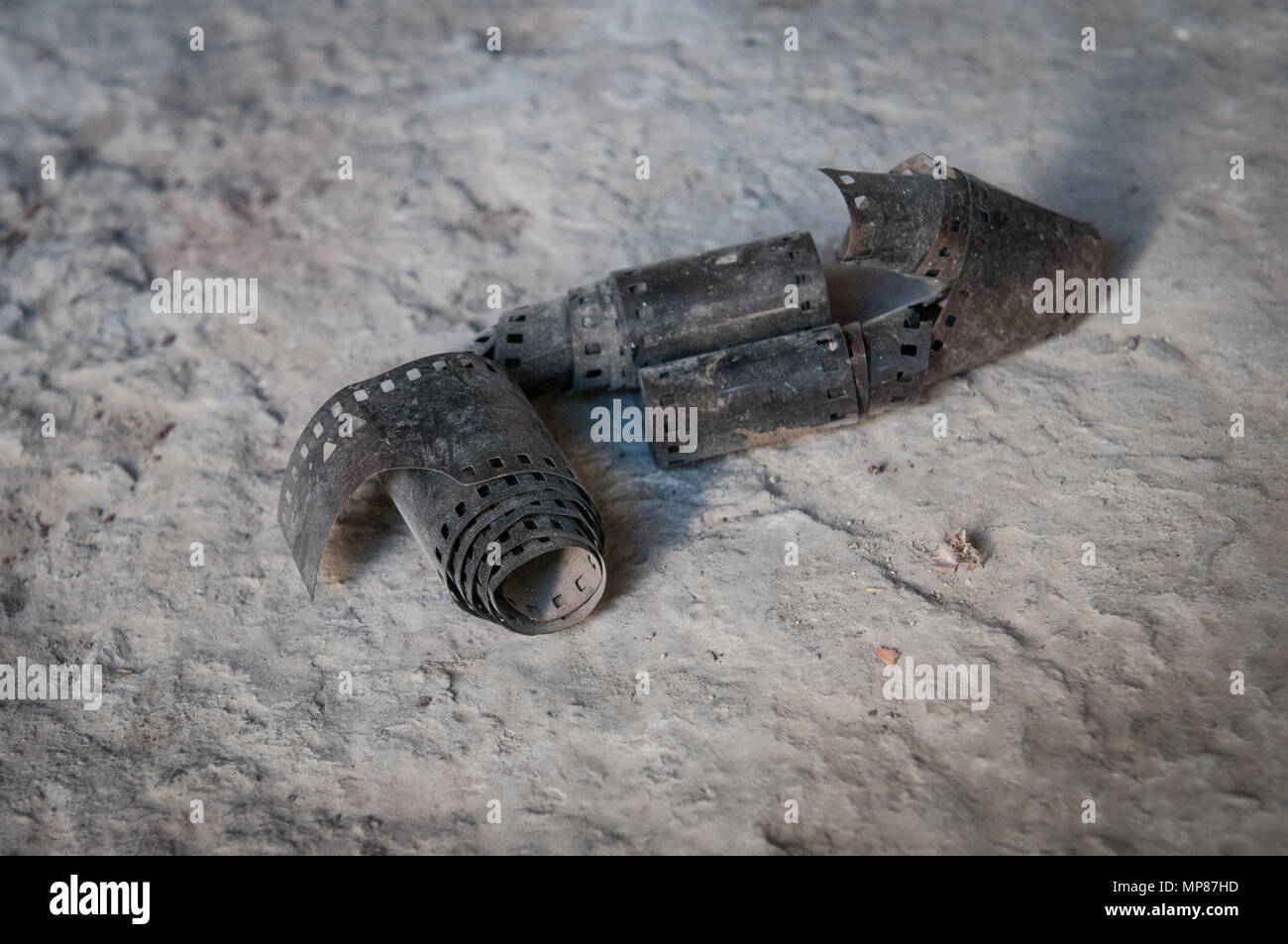 Old vintage strip of 35mm film abandoned on the ground Stock Photo
