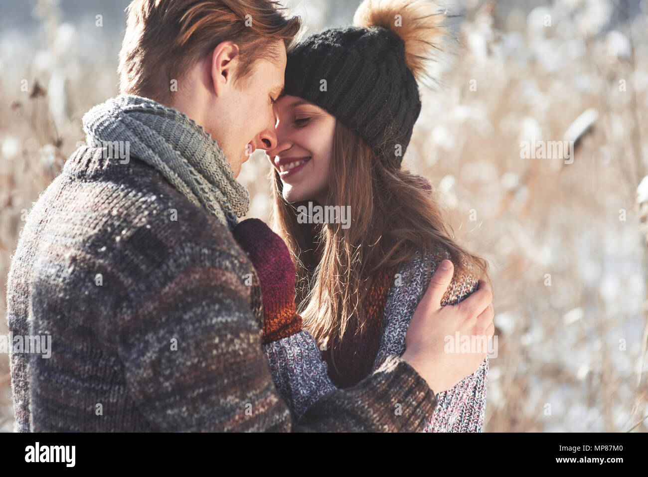 Happy Young Couple in Winter Park having fun.Family Outdoors. Stock Photo