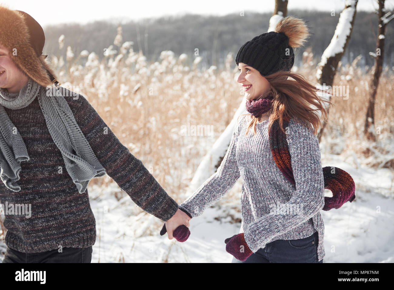 people, season, love and leisure concept - happy couple having fun over winter background Stock Photo