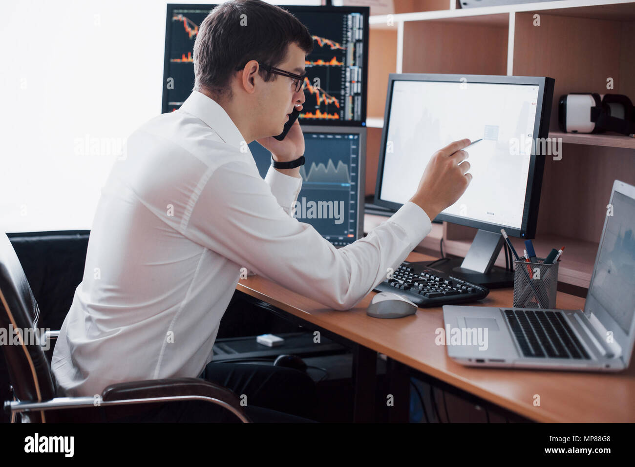 Stockbroker In Shirt Is Working In A Monitoring Room With Display - 