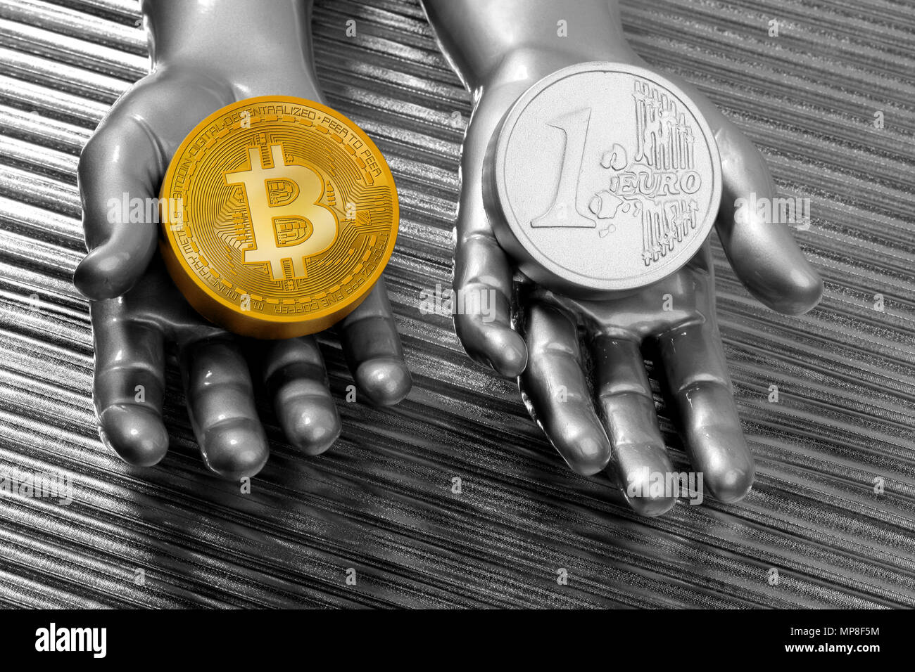 Bitcoin vs euro coins concept on silver futuristic hands Stock Photo - Alamy