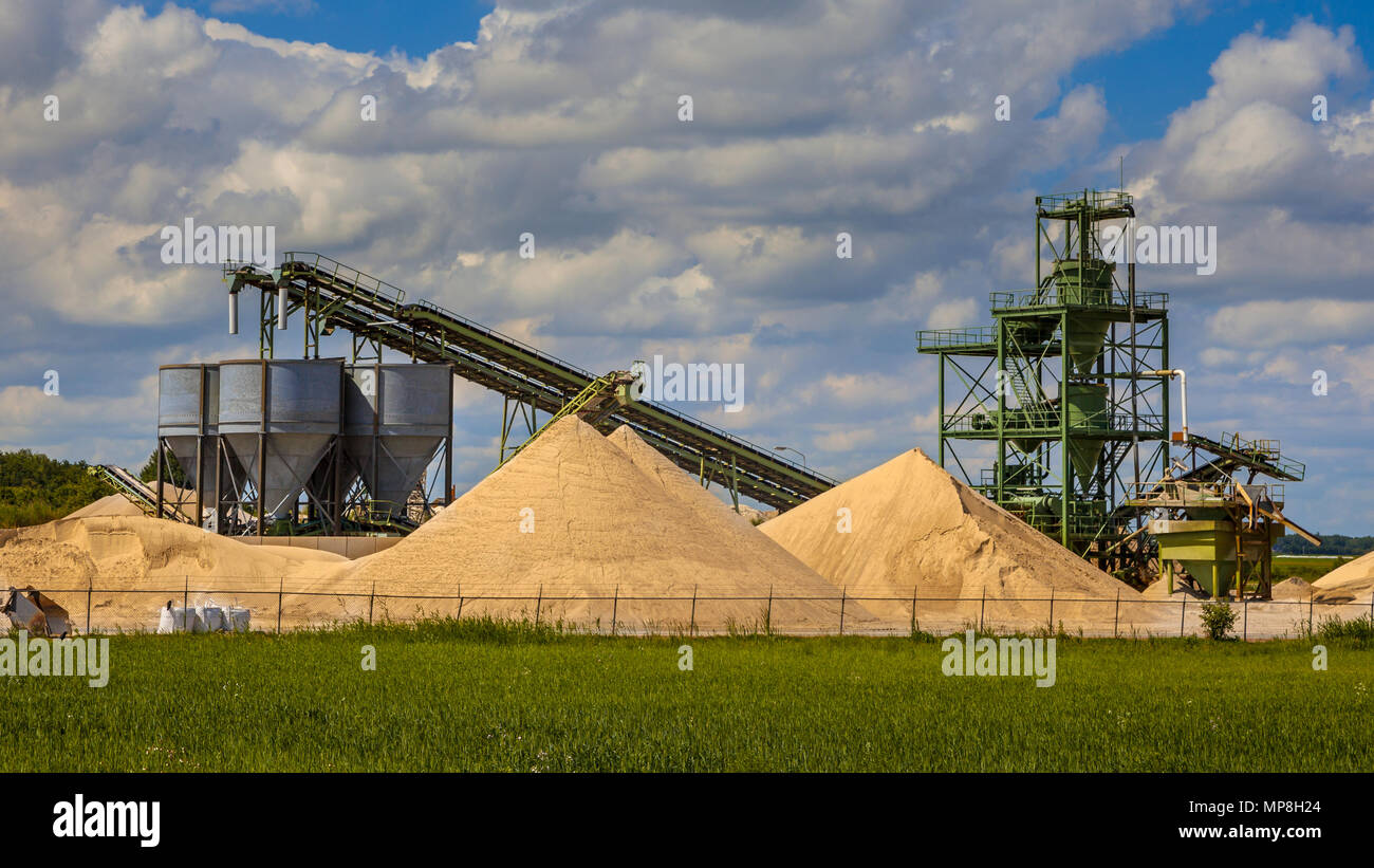 Sand mining terminal facility with conveyer belts and silos on a clouded summer day Stock Photo