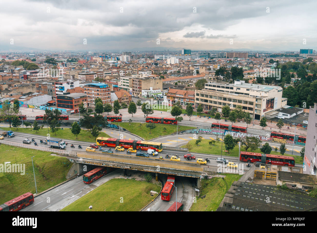 aerial view of early morning rush hour traffic featuring numerous taxis and articulated Transmilenio buses in Colombia's capital, Bogotá Stock Photo