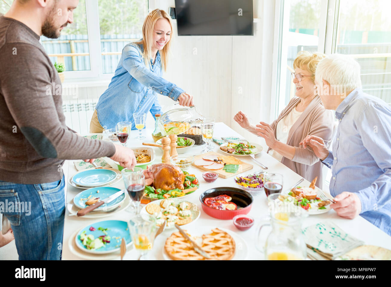 Happy Family Dinner in Modern Apartment Stock Photo - Alamy