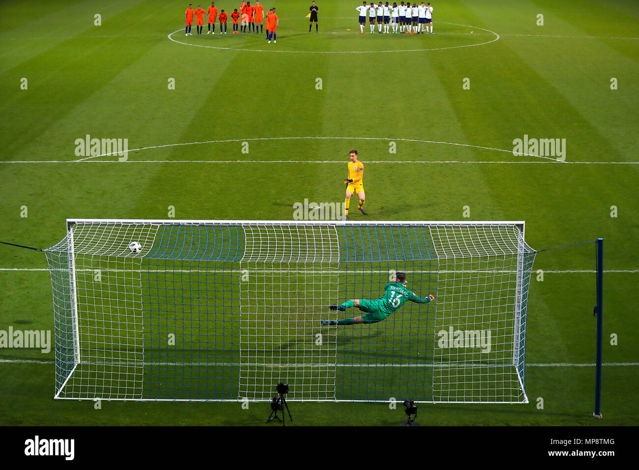 England goalkeeper Luca Ashby-Hammond takes a penalty against Netherland's Joey Koorevaar Stock Photo