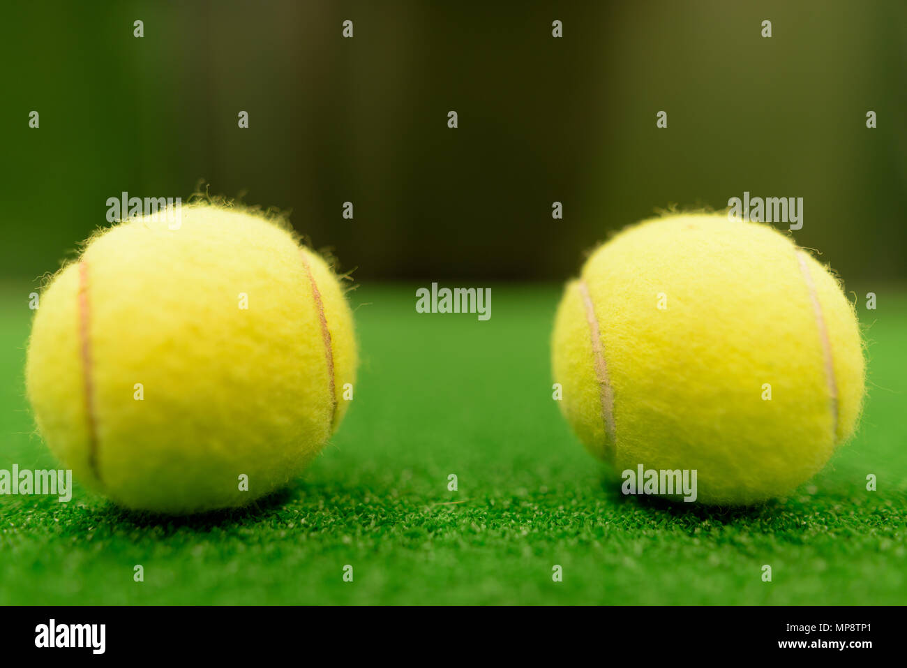 Tennis Balls On Green Surface Stock Photo