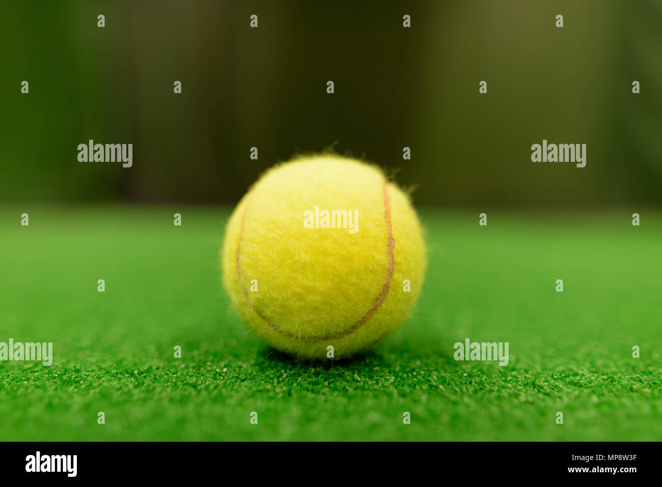 Tennis Balls On Green Surface Stock Photo