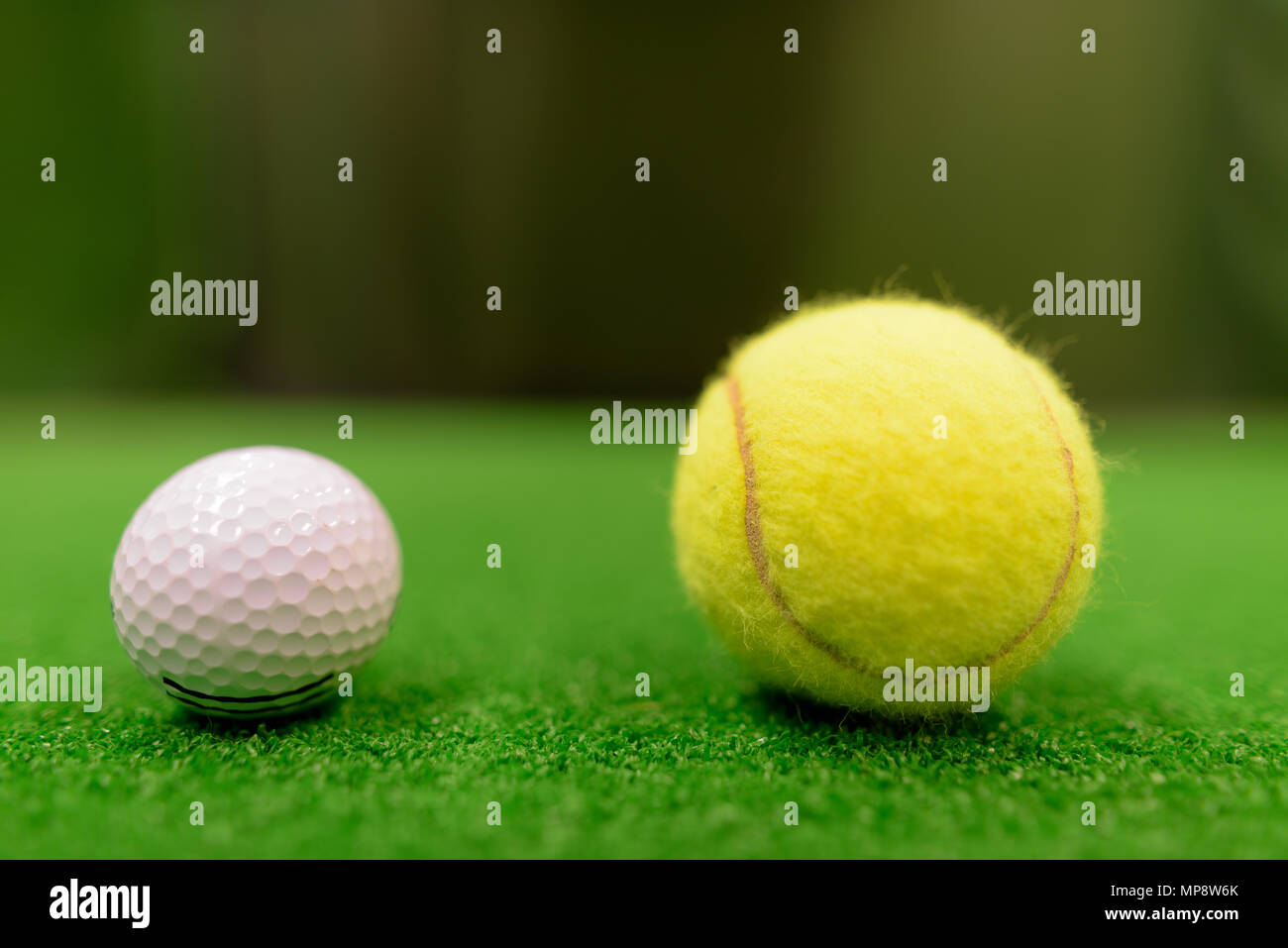 Golf Ball And Tennis Ball On Green Surface Stock Photo