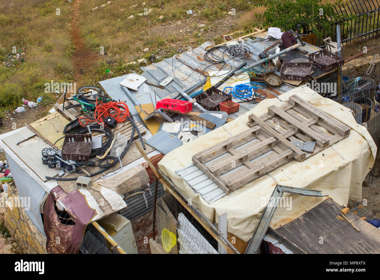 Waste thoughtlessly piled upon rooftops of Arab homes in the city of Jerusalem and clearly visible to tourists from the rooftop of the historic Herod Stock Photo
