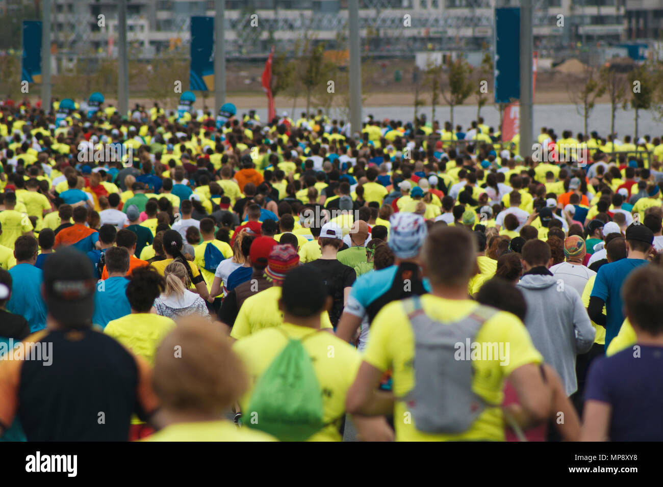 https://c8.alamy.com/comp/MP8XY8/gray-day-city-marathon-a-lot-of-running-people-in-sports-clothes-in-the-background-of-the-lake-and-the-house-blurred-background-MP8XY8.jpg