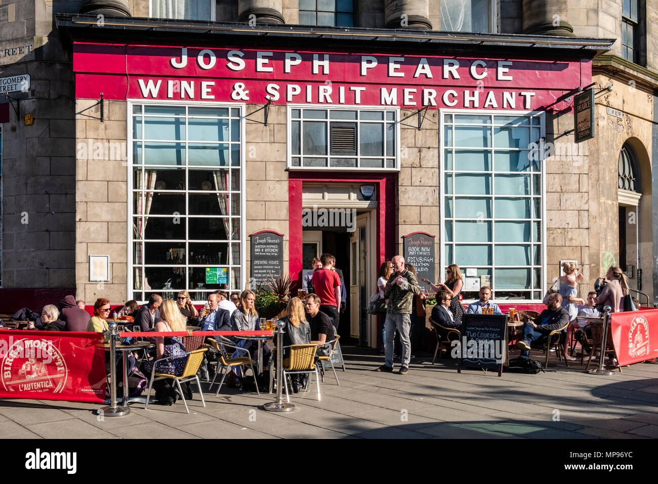 Exterior of Joseph Pearce pub with people drinking outside on warm evening on Elm Row in Edinburgh, Scotland, UK, United Kingdom Stock Photo