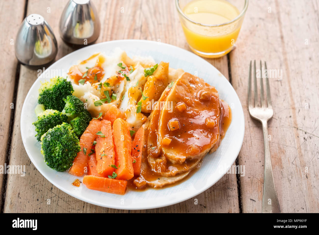 Sliced roast pork in apple & cider gravy with mashed potatoes, carrots