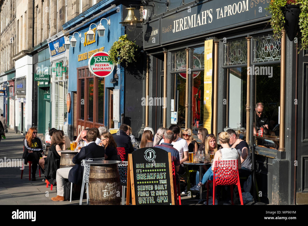 Exterior of Jeremiah's Taproom pub with people drinking outside on warm evening on Elm Row in Edinburgh, Scotland, UK, United Kingdom Stock Photo
