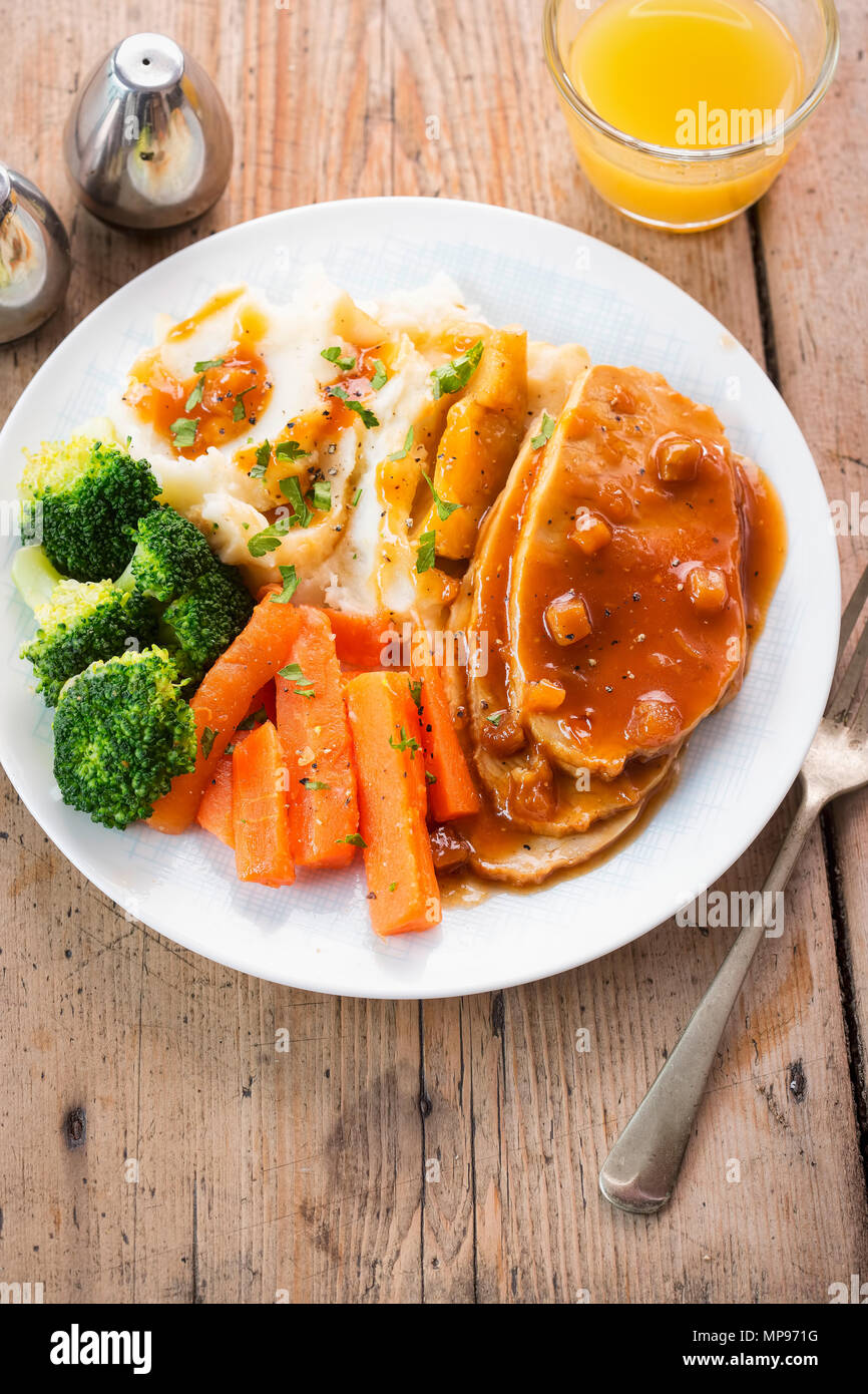 Sliced roast pork in apple & cider gravy with mashed potatoes, carrots