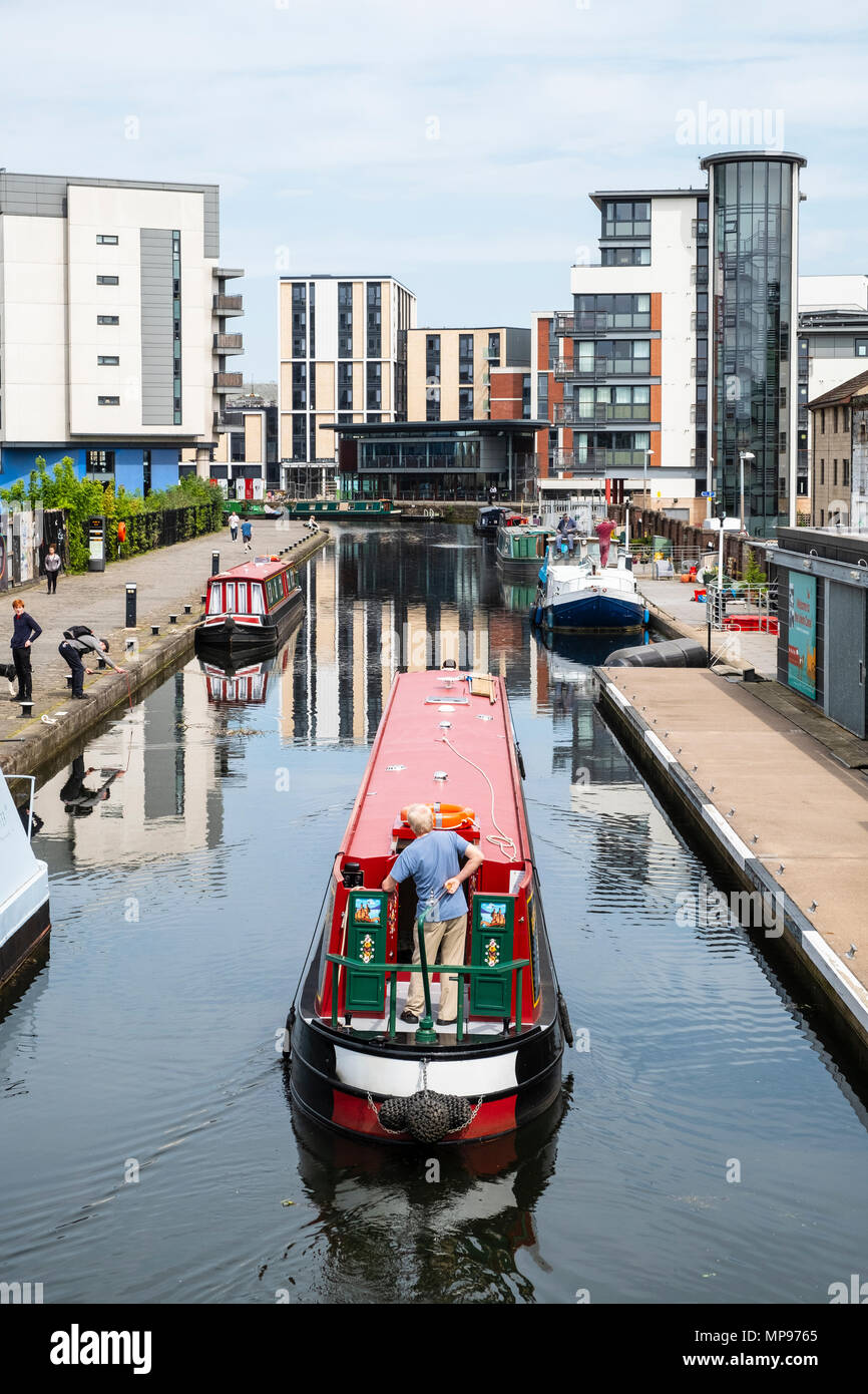 View of Union Canal at Lochrin Basin with narrow boat sailing to mooring at Fountainbridge in Edinburgh, Scotland, United Kingdom, UK Stock Photo