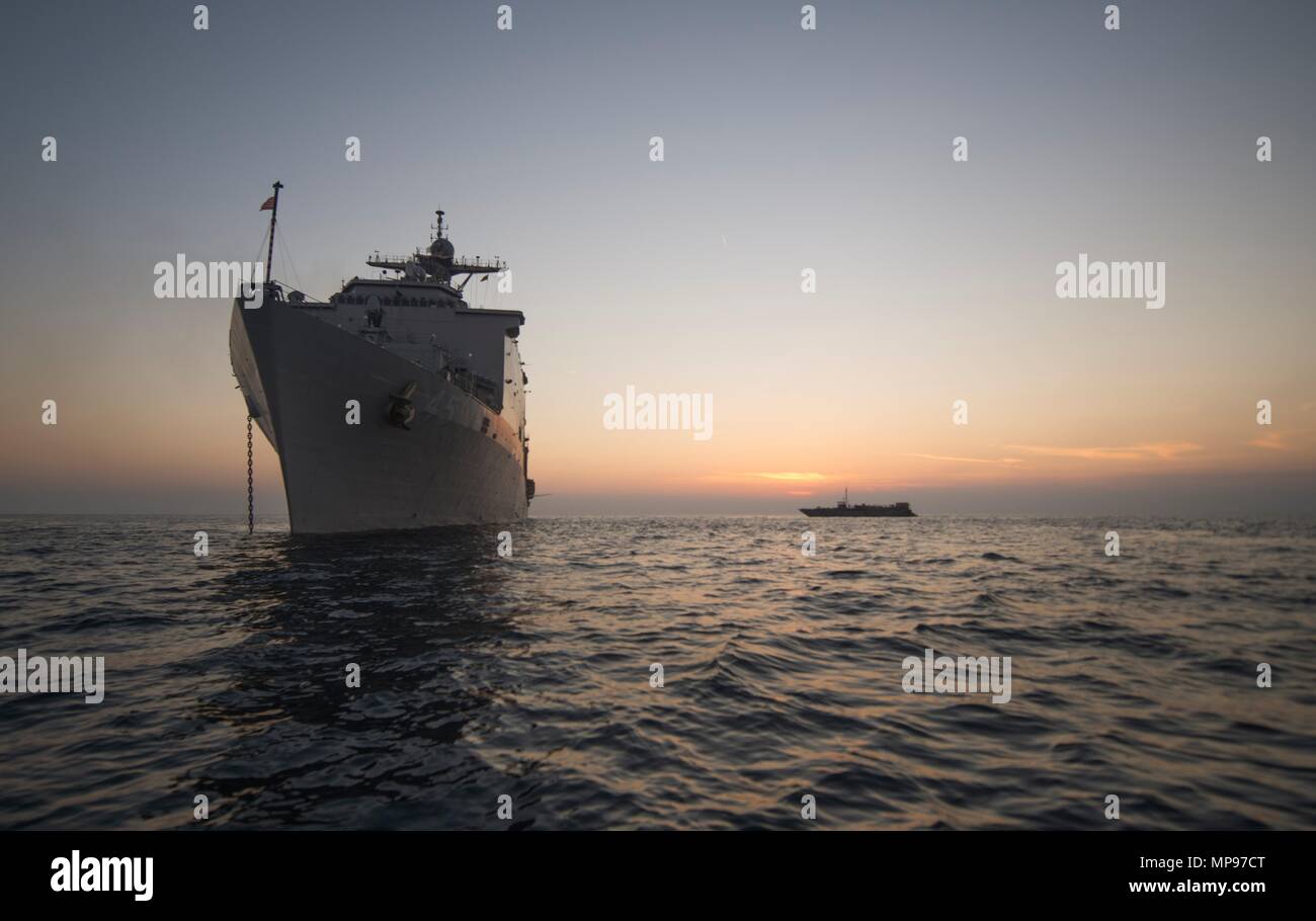 The U.S. Navy Whidbey Island-class amphibious dock landing ship USS Comstock anchors at sunset December 9, 2014 in the Arabian Gulf.   (photo by Lenny LaCrosse via Planetpix) Stock Photo