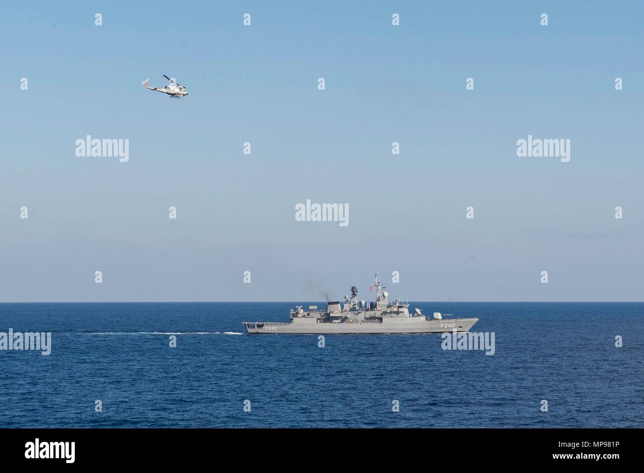 A U.S. Navy Agusta AB 212 helicopter flies over the Turkish Navy Yavuz-class guided-missile frigate TCG Yavuz October 15, 2015 in the Mediterranean Sea.   (photo by Jackie Hart via Planetpix) Stock Photo