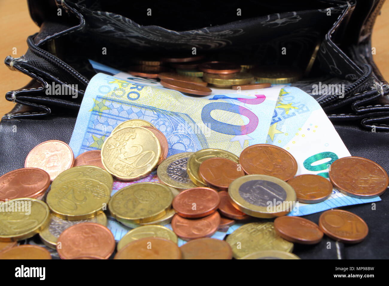 Euro coins and notes take out of a black purse Stock Photo