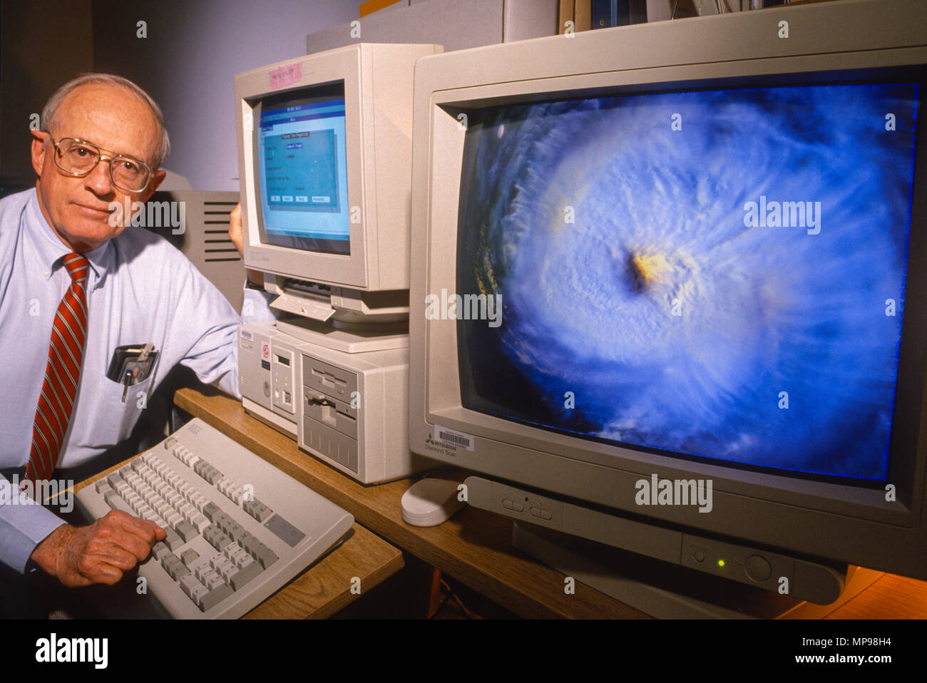 WASHINGTON, DC, USA -NOVEMBER 2, 1993: William M. Callicott, N.O.A.A. and satellite image of Hurrican Emily on computer screen. Stock Photo
