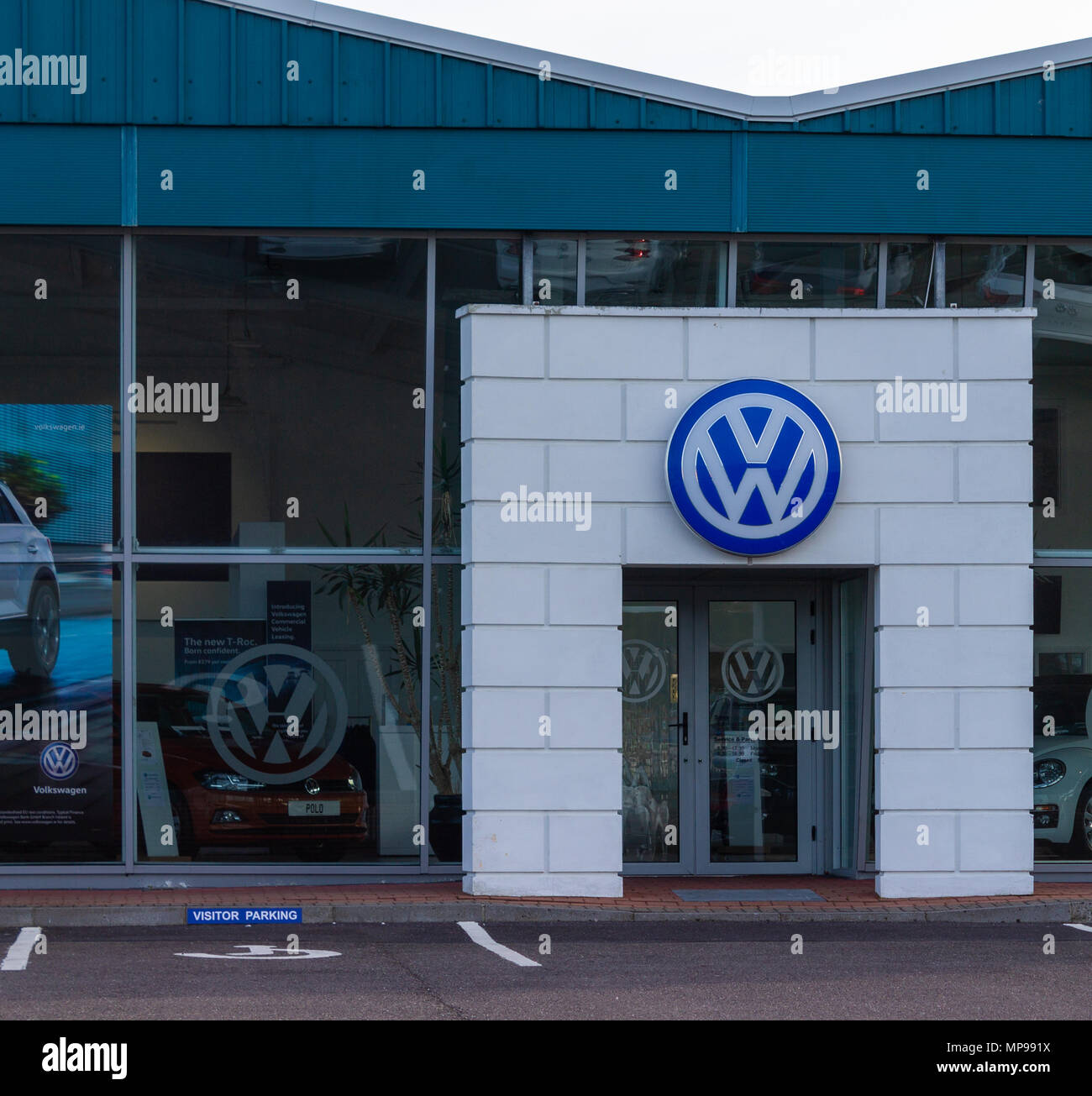 Volkswagen logo above the doorway entrance to a volkswagen saleroom Stock Photo