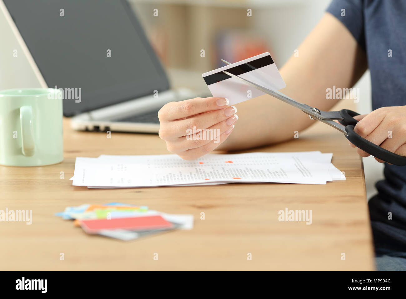 Close up of a woman hands destroying old credit cards Stock Photo