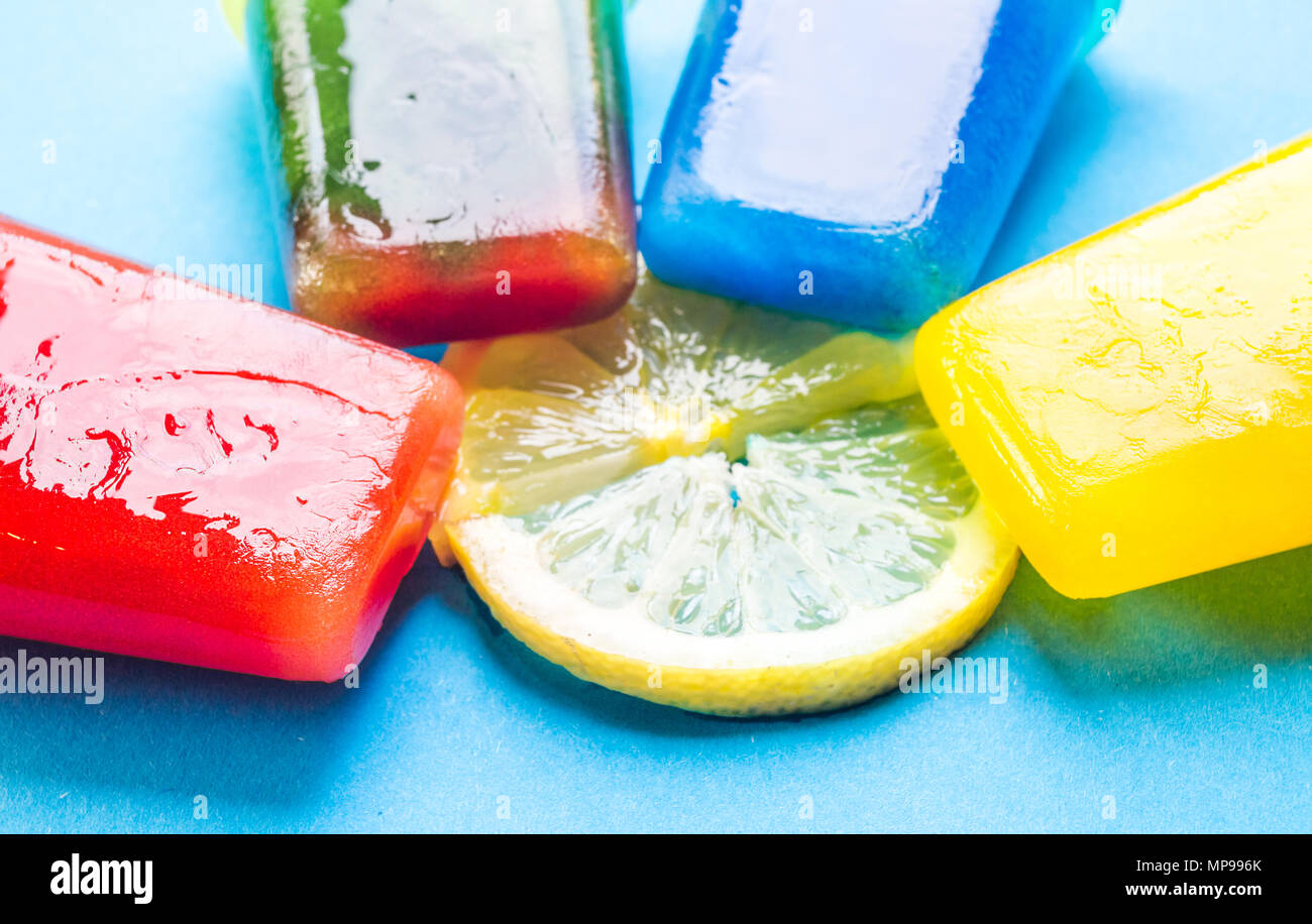 Homemade popsicles isolated on blue and yellow background Stock Photo