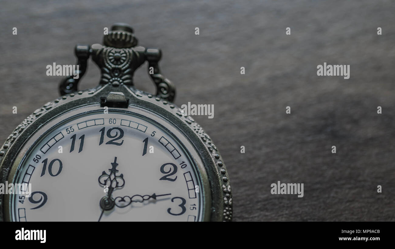 old vintage pocket watch showing time on wooden background Stock Photo