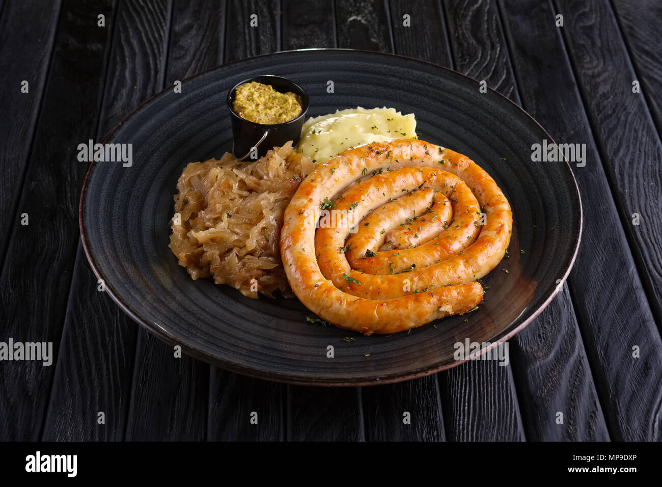 Homemade sausage with braised cabbage and mashed potato Stock Photo