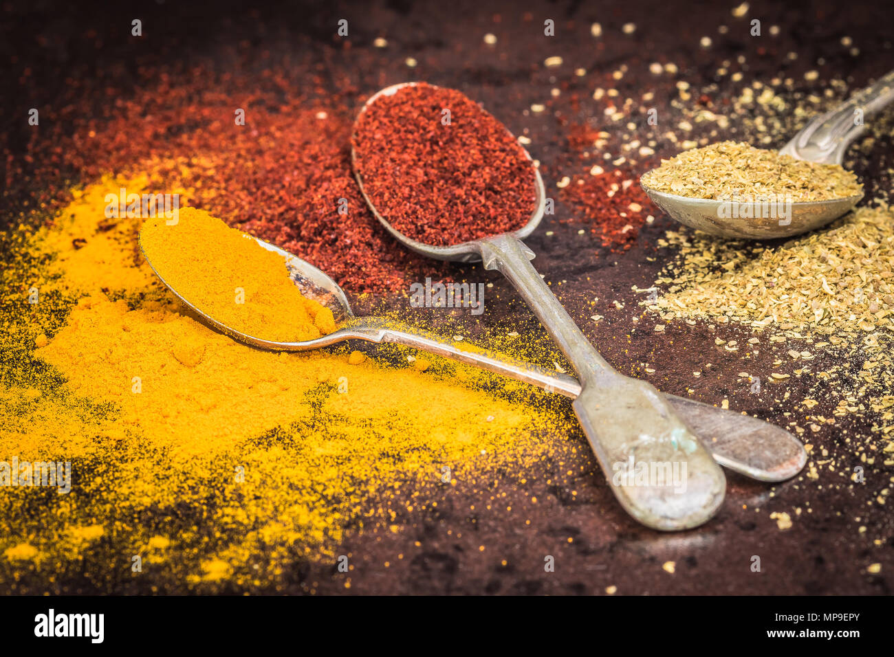 Various spices such as Turmeric & paprika on spoons, close up Stock Photo