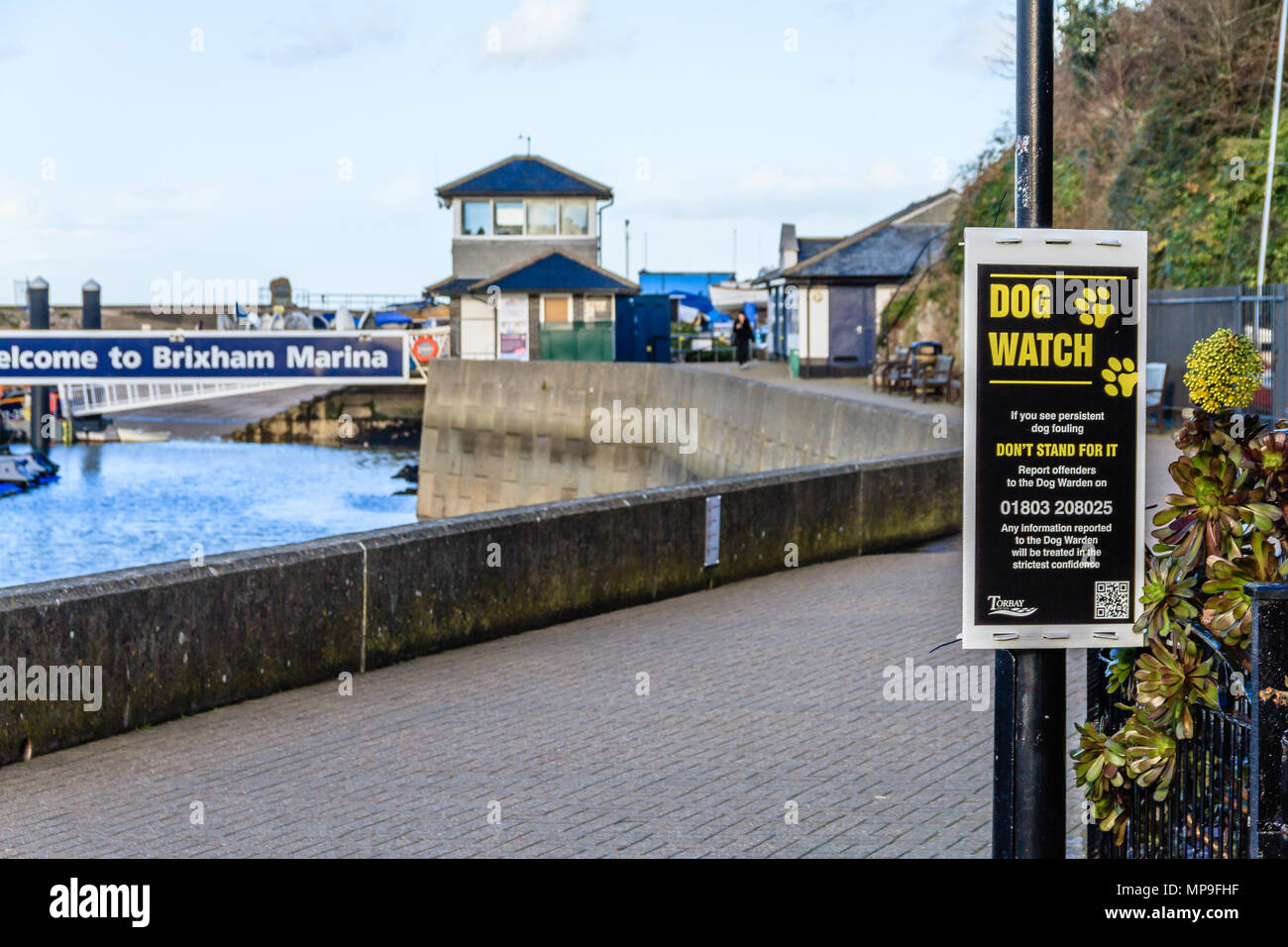 Dog Watch sign on the quayside at Brixham harbour and marina, Devon. March 2018. Stock Photo