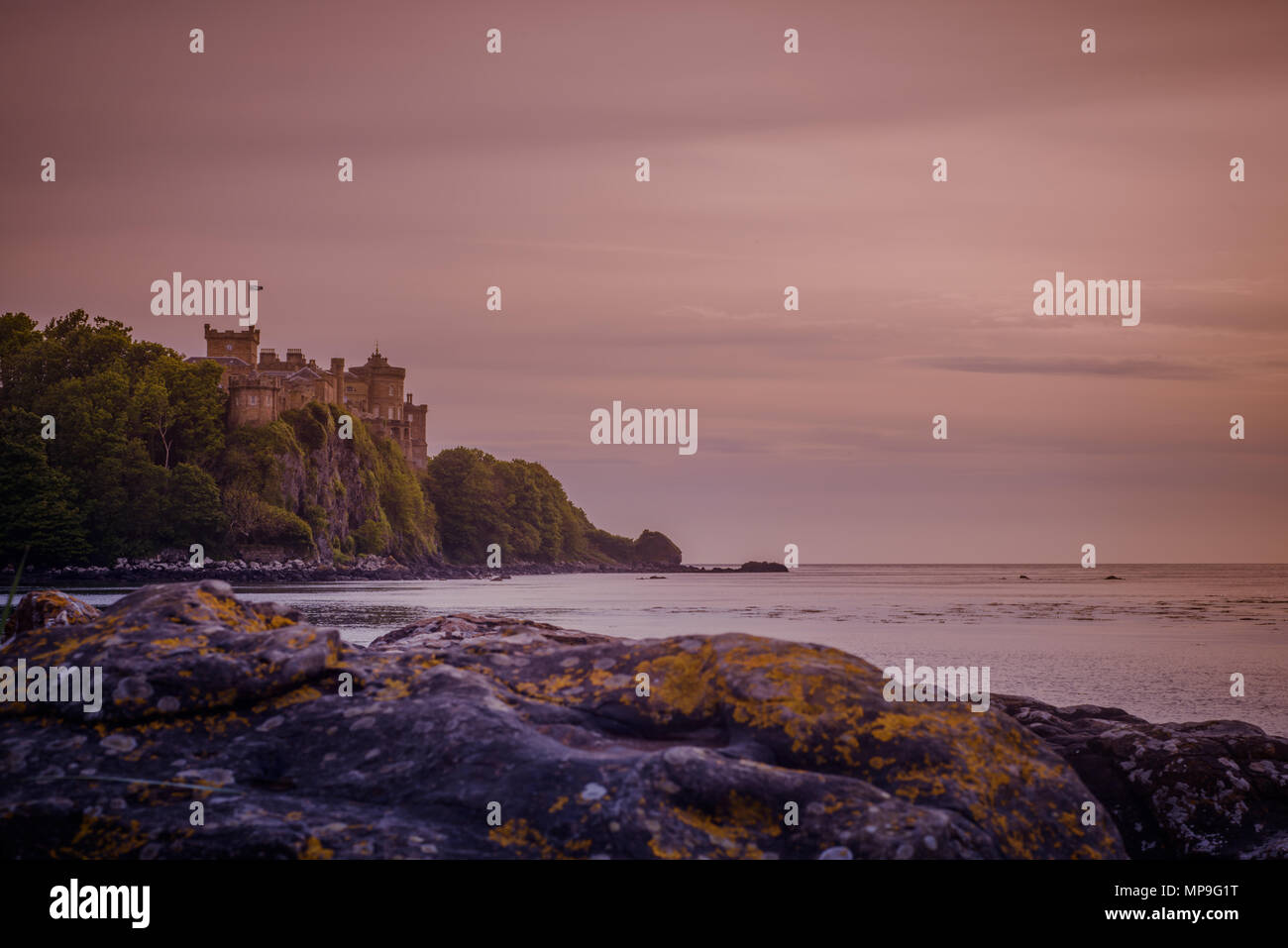 View of Culzean Castle on the West Coast of Scotland at Sunset from the Beach Stock Photo