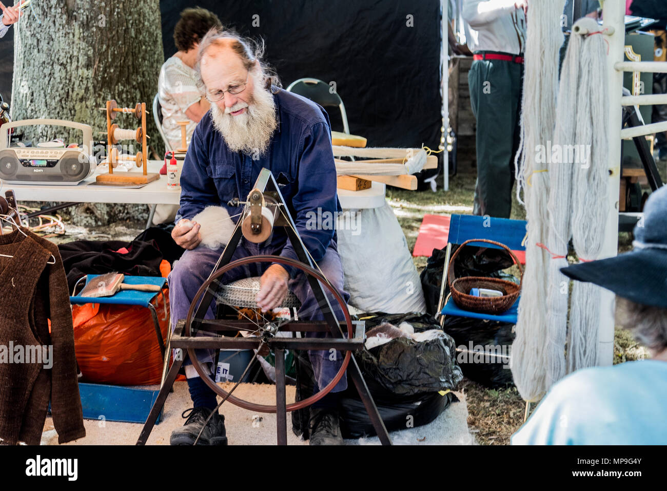 Old man spinning wool on a loom Stock Photo - Alamy