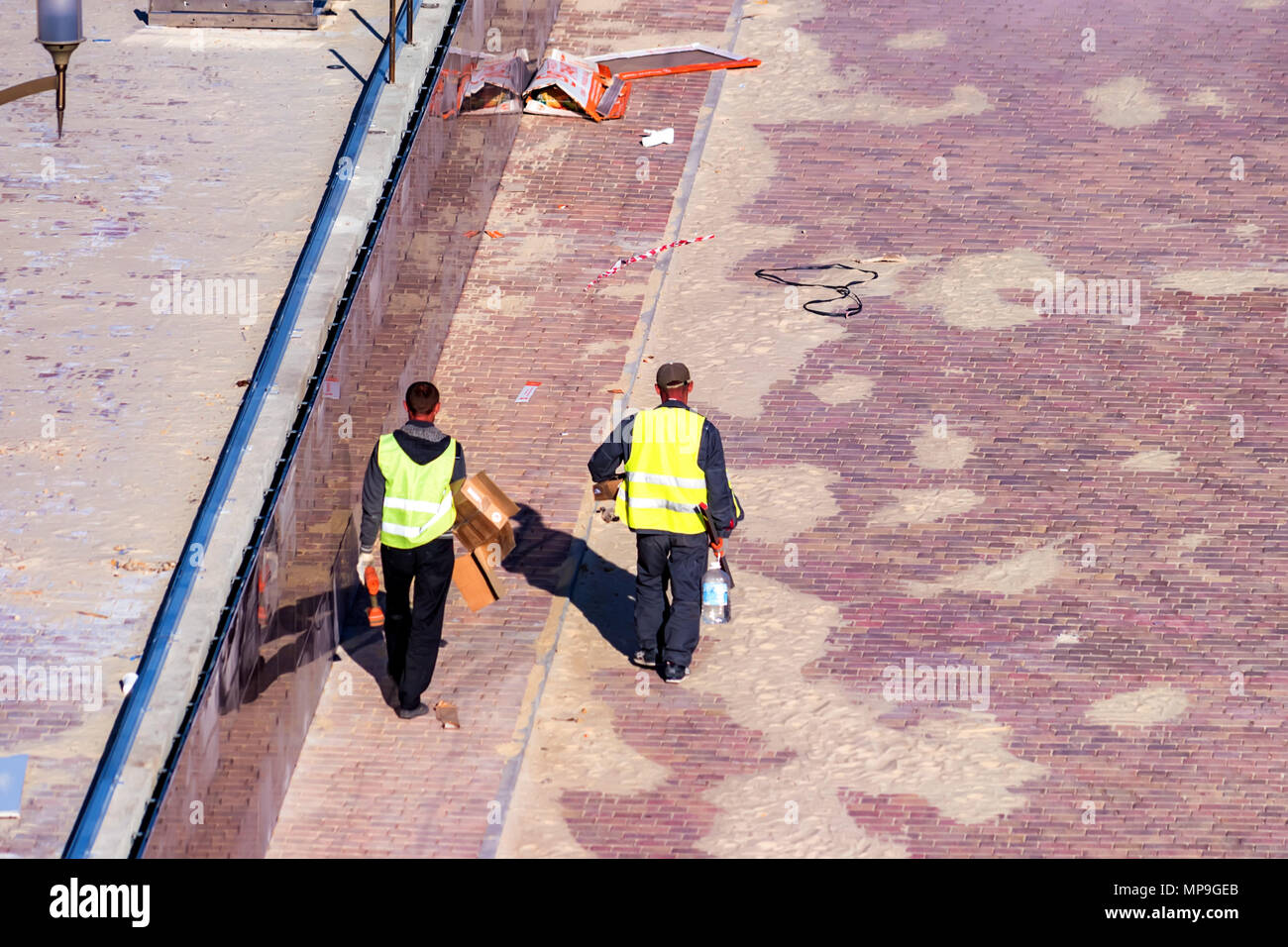 Workers pave sidewalk Stock Photo