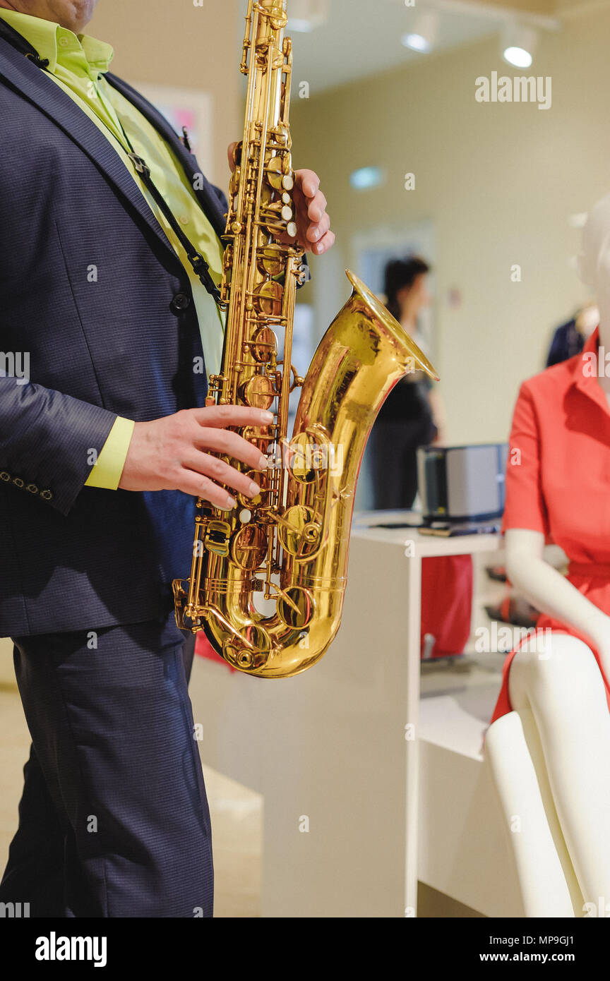 musician plays the saxophone performance at a concert in shopping