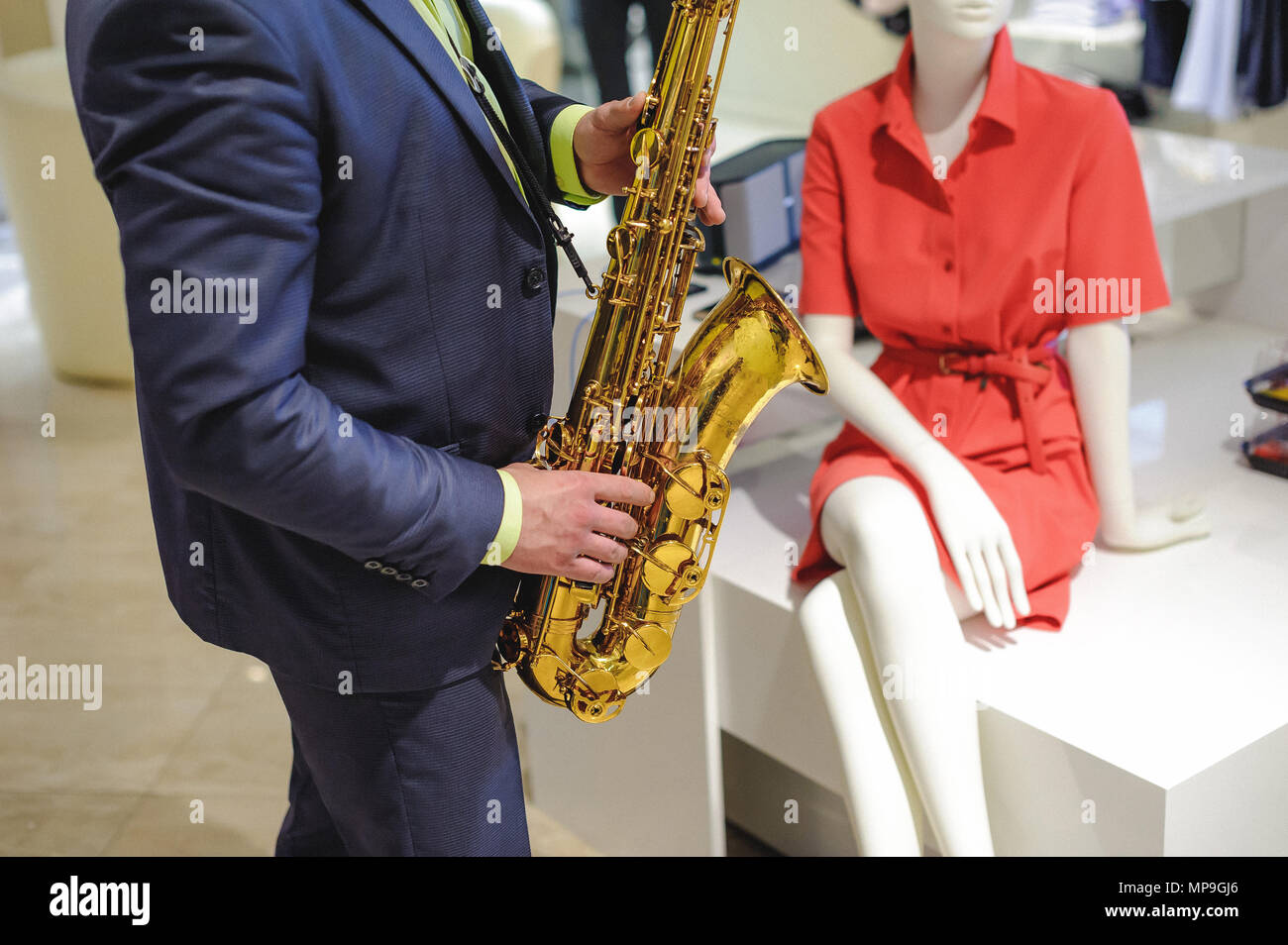 musician plays the saxophone performance at a concert in shopping