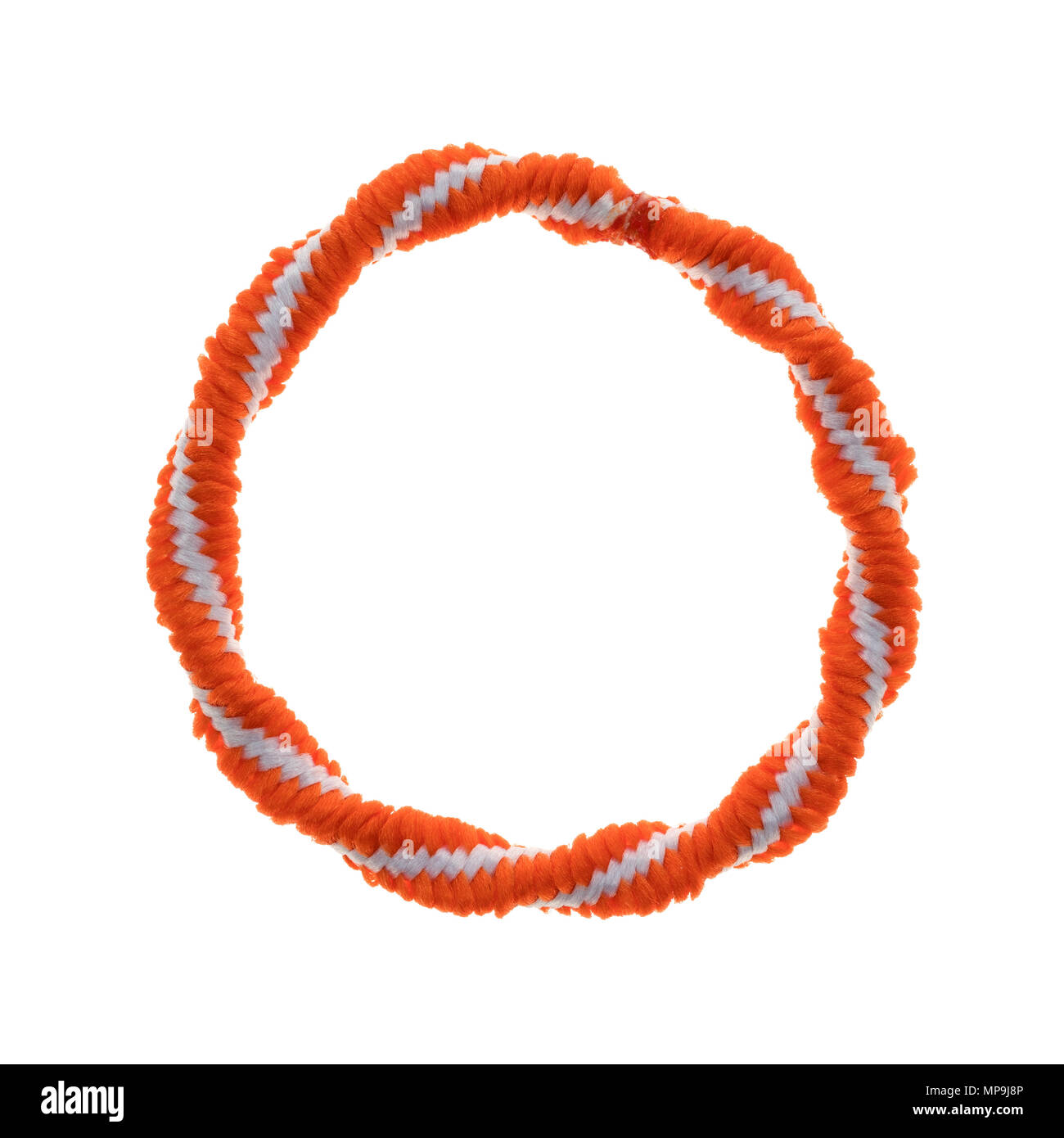 Top view of a colorful orange and white ponytail tie isolated on a white background. Stock Photo