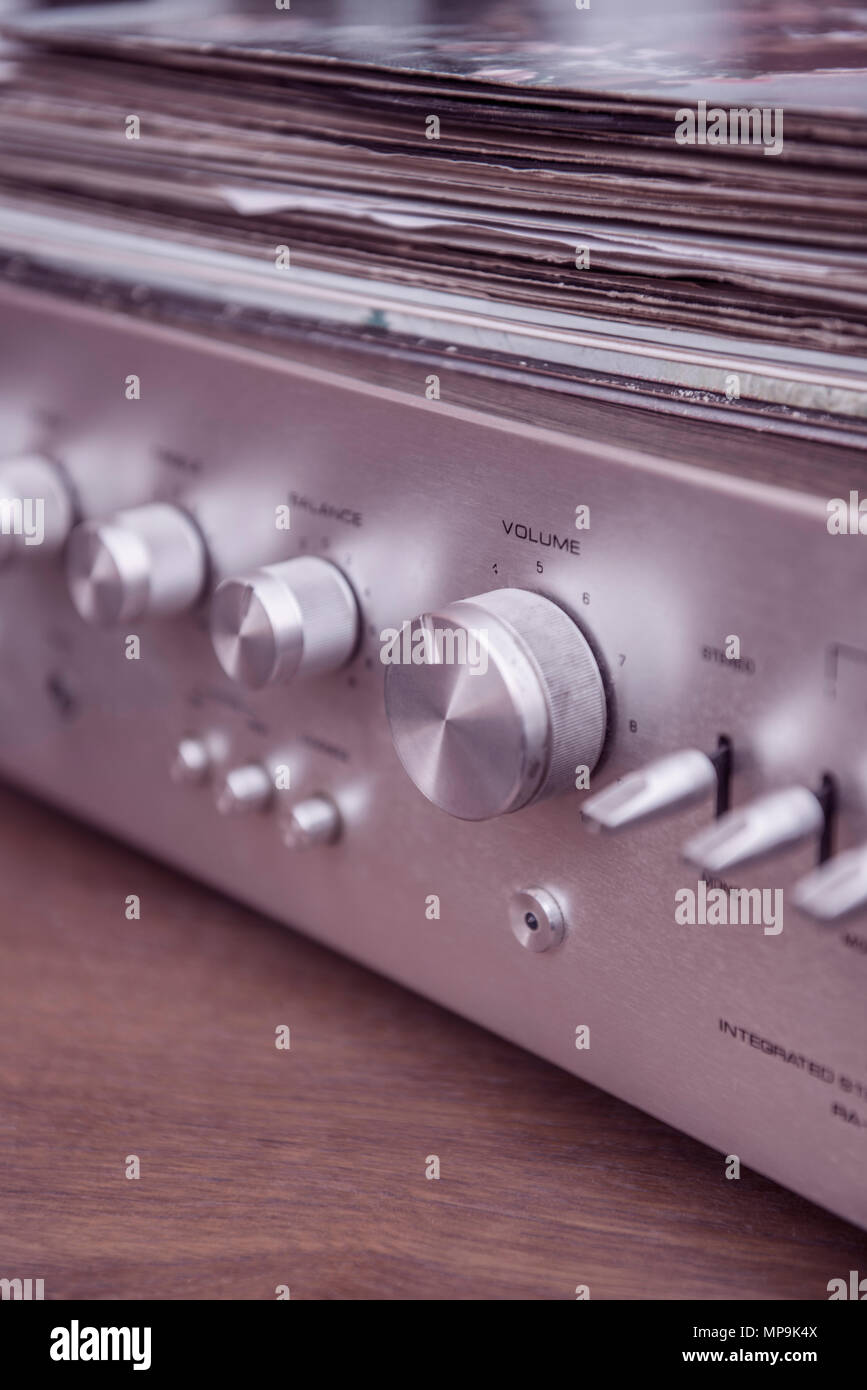 Vinyl records on top of a stereo music amplifier Stock Photo Alamy