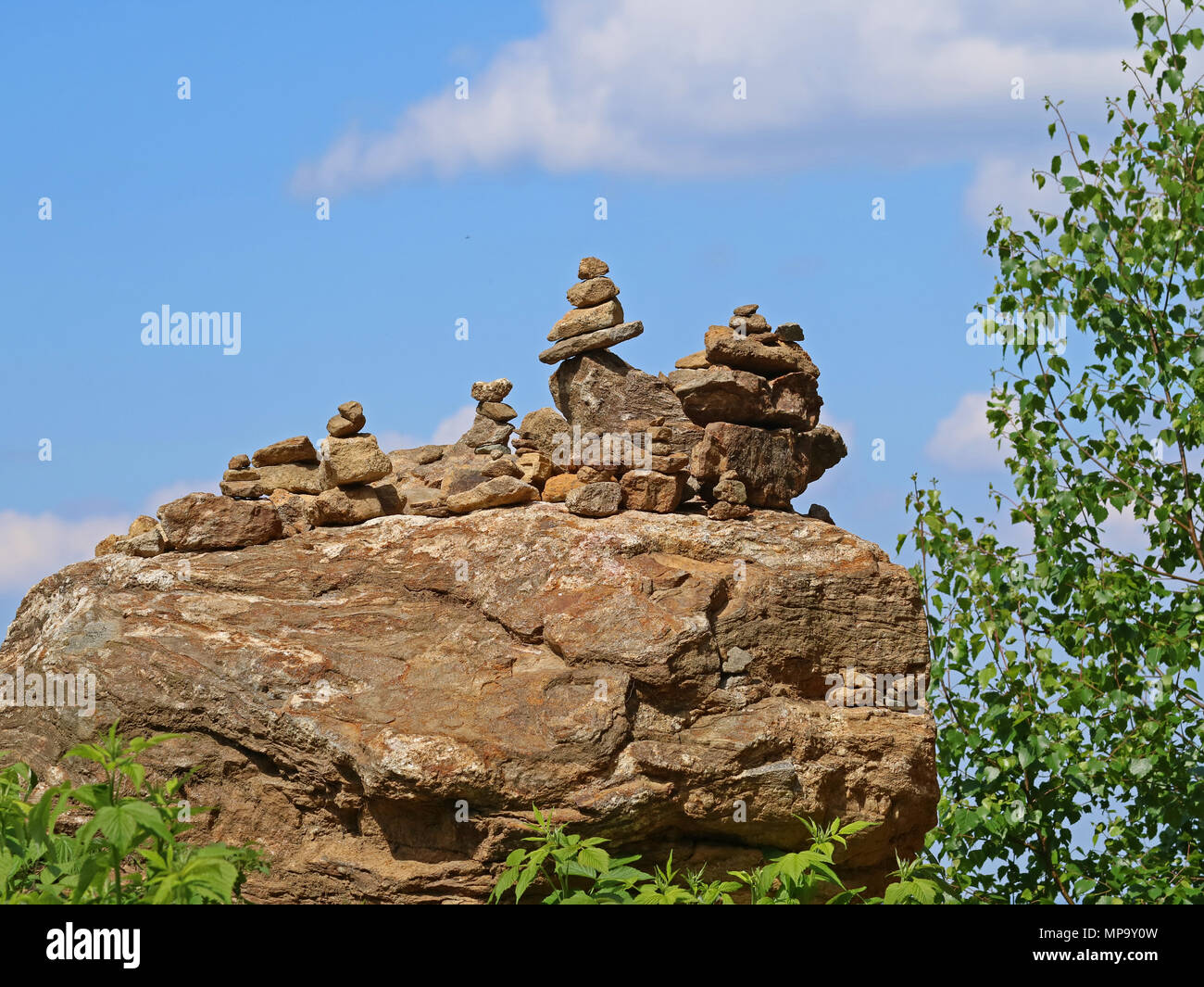 Piles of rocks with blue sky in the background Stock Photo