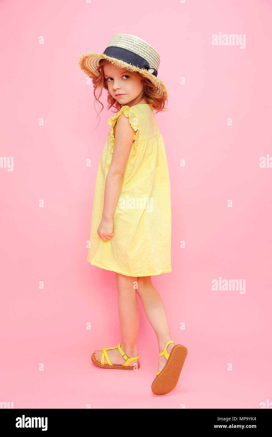 Charming girl in dress on pink Stock Photo - Alamy