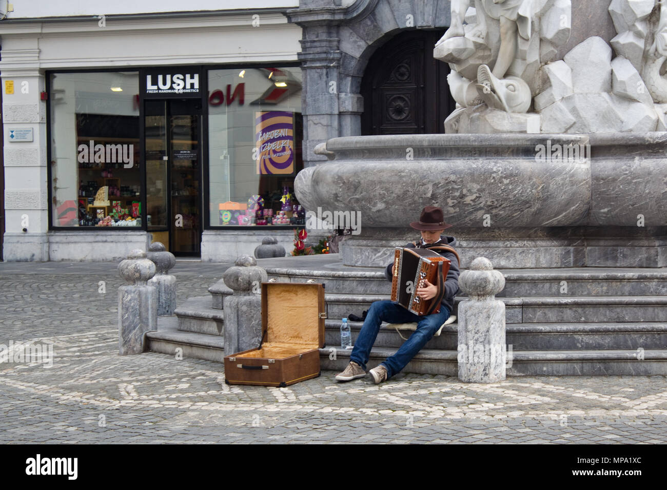 A young man playing  an accordion in the streets of Ljubljana Stock Photo