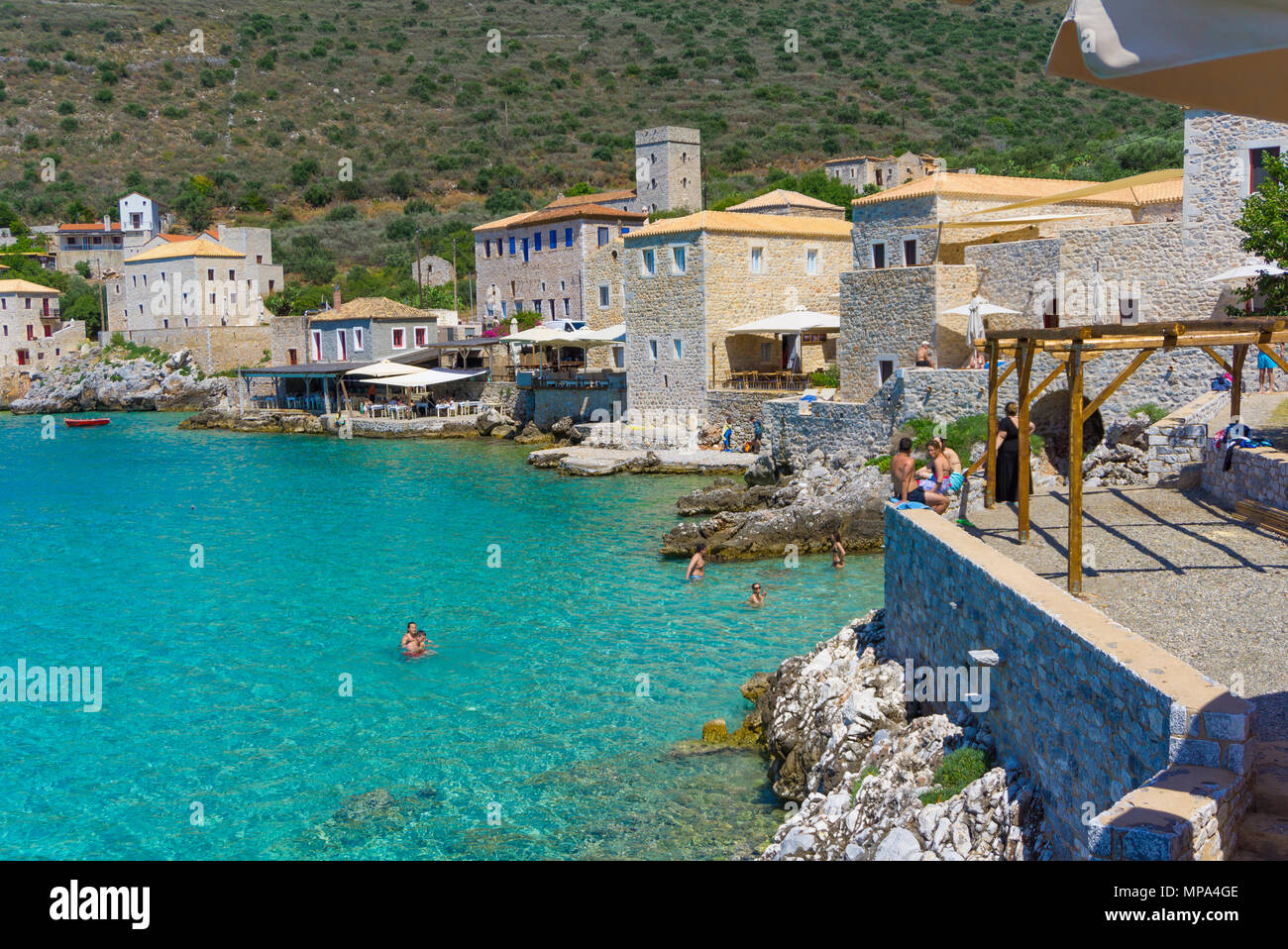 Limeni village in Mani, Peloponnese, Greece. People swimming in
