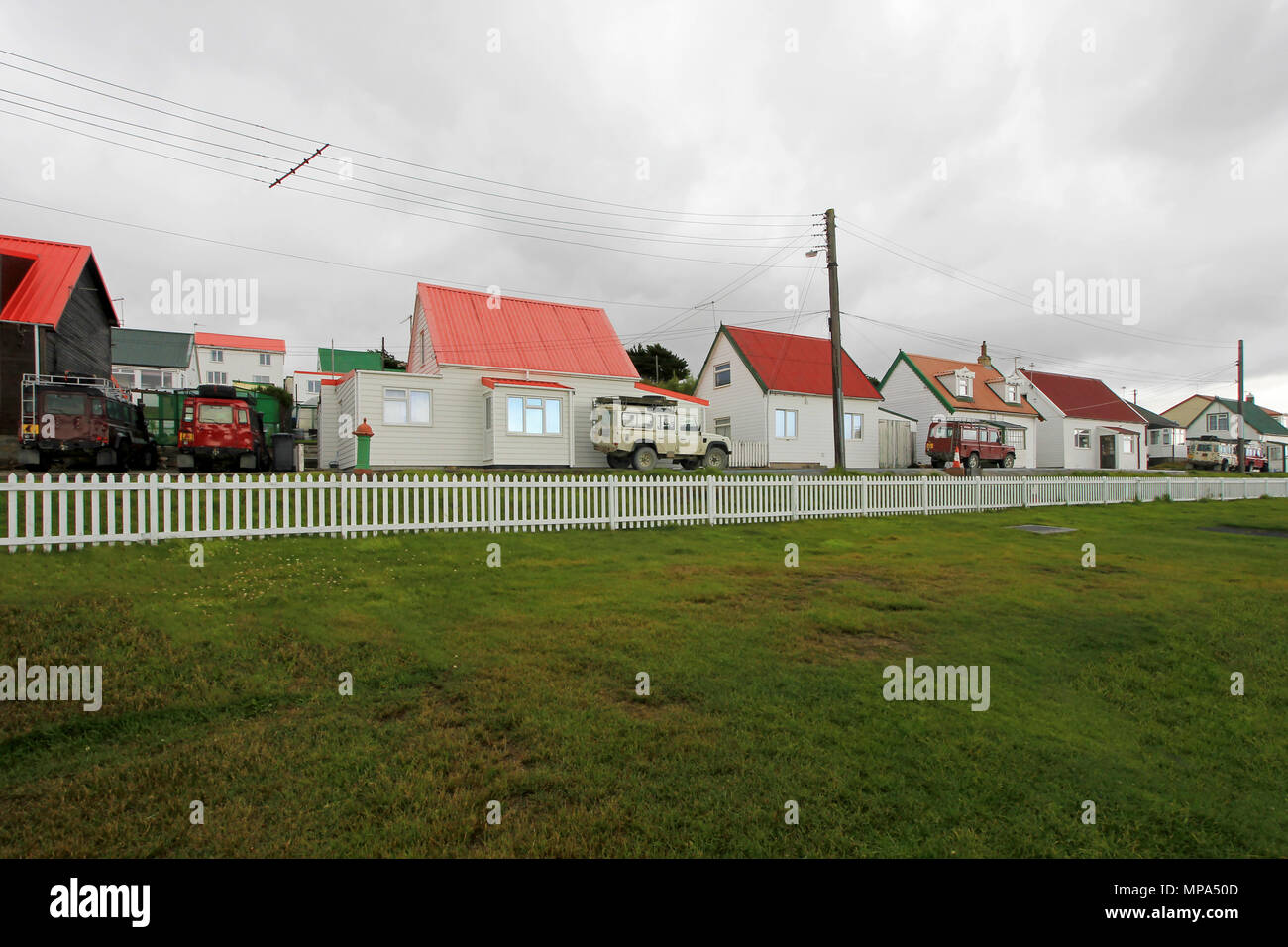 Brithis cars in front of typical british town houses in Port Stanley